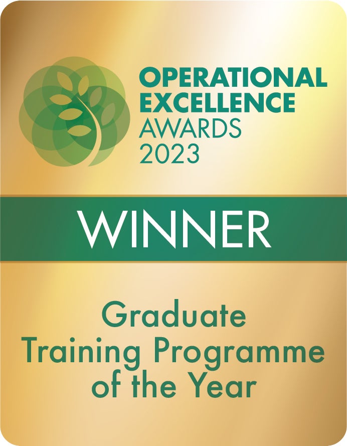 A gold award badge for the 'Operational Excellence Awards 2023' with a green tree logo. Text indicates the status is 'WINNER' for 'Graduate Training Programme of the Year.