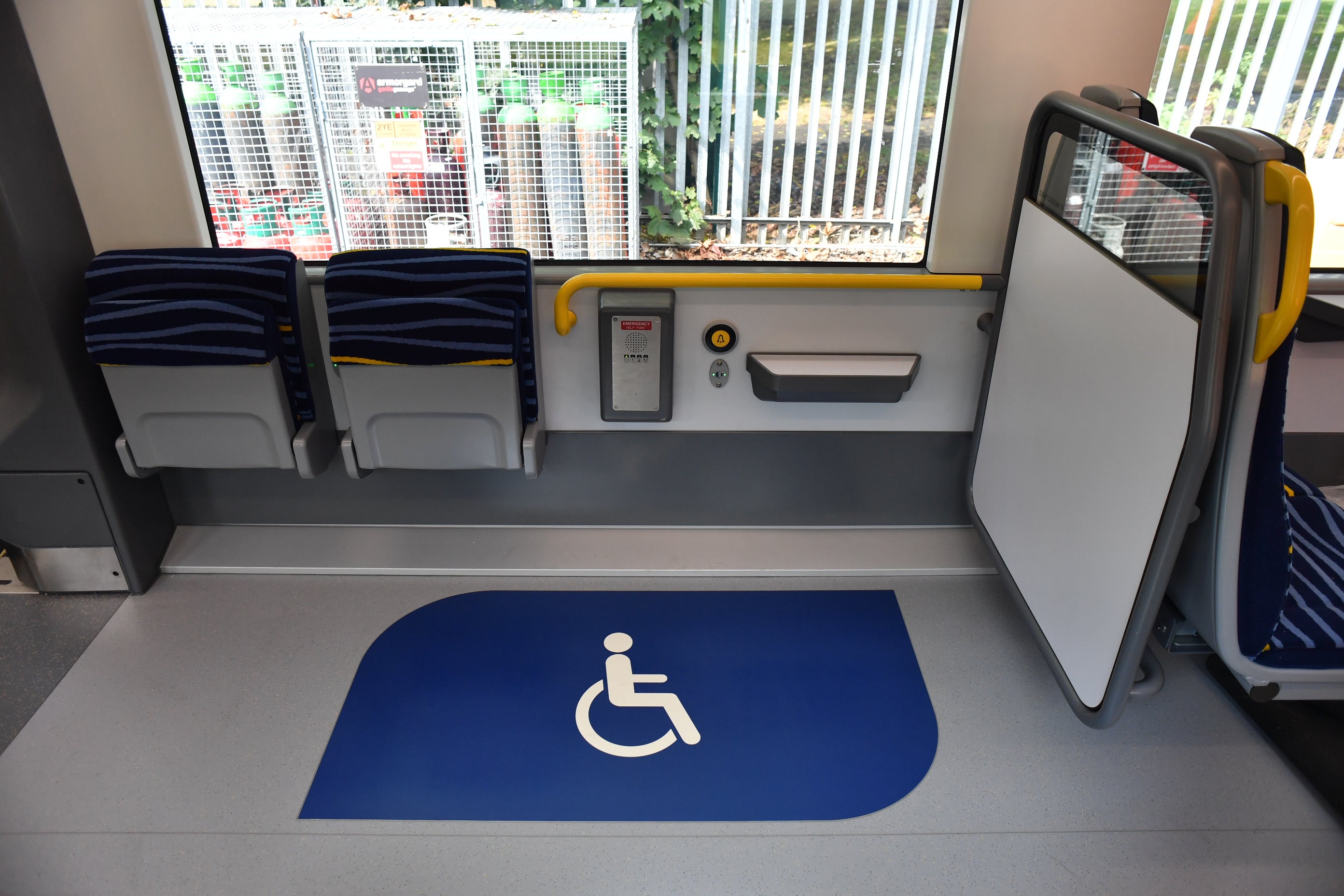 Interior image of new DART carriage (showing wheelchair space with two flip up seats within the wheelchair area)
