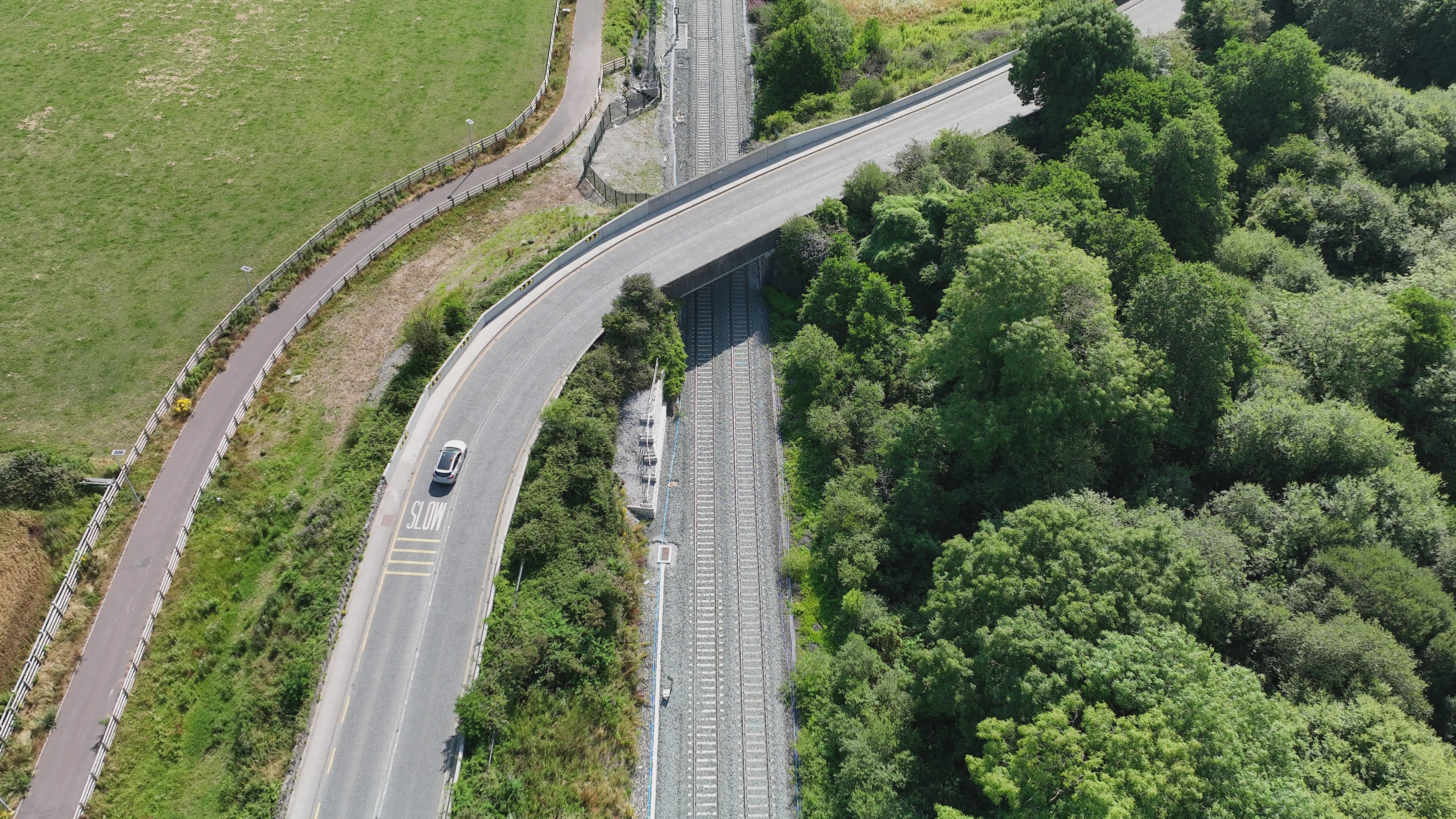 Aerial view of the Glounthaune to Midleton overpass. Road bridge provides a grade-separated crossing over the railway line. 